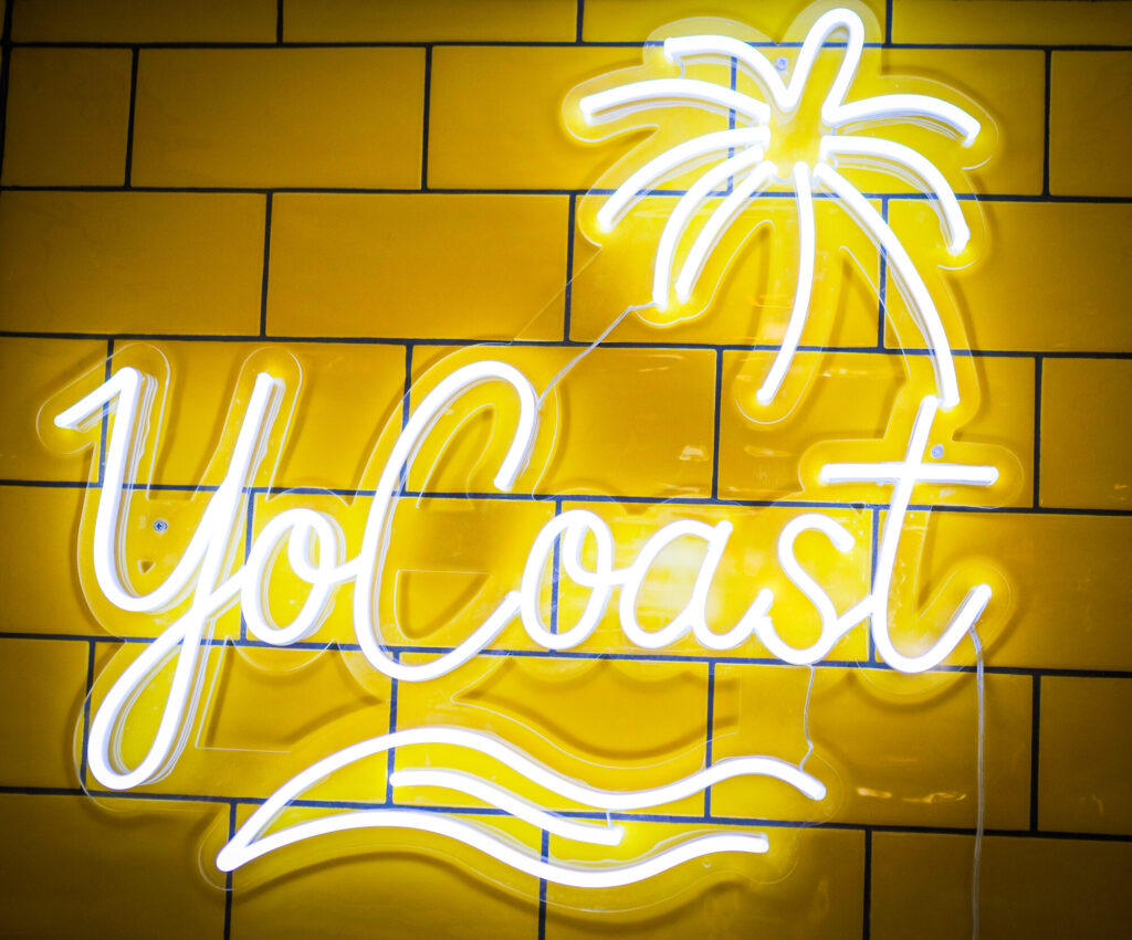 Yo Coast neon sign inside the venue