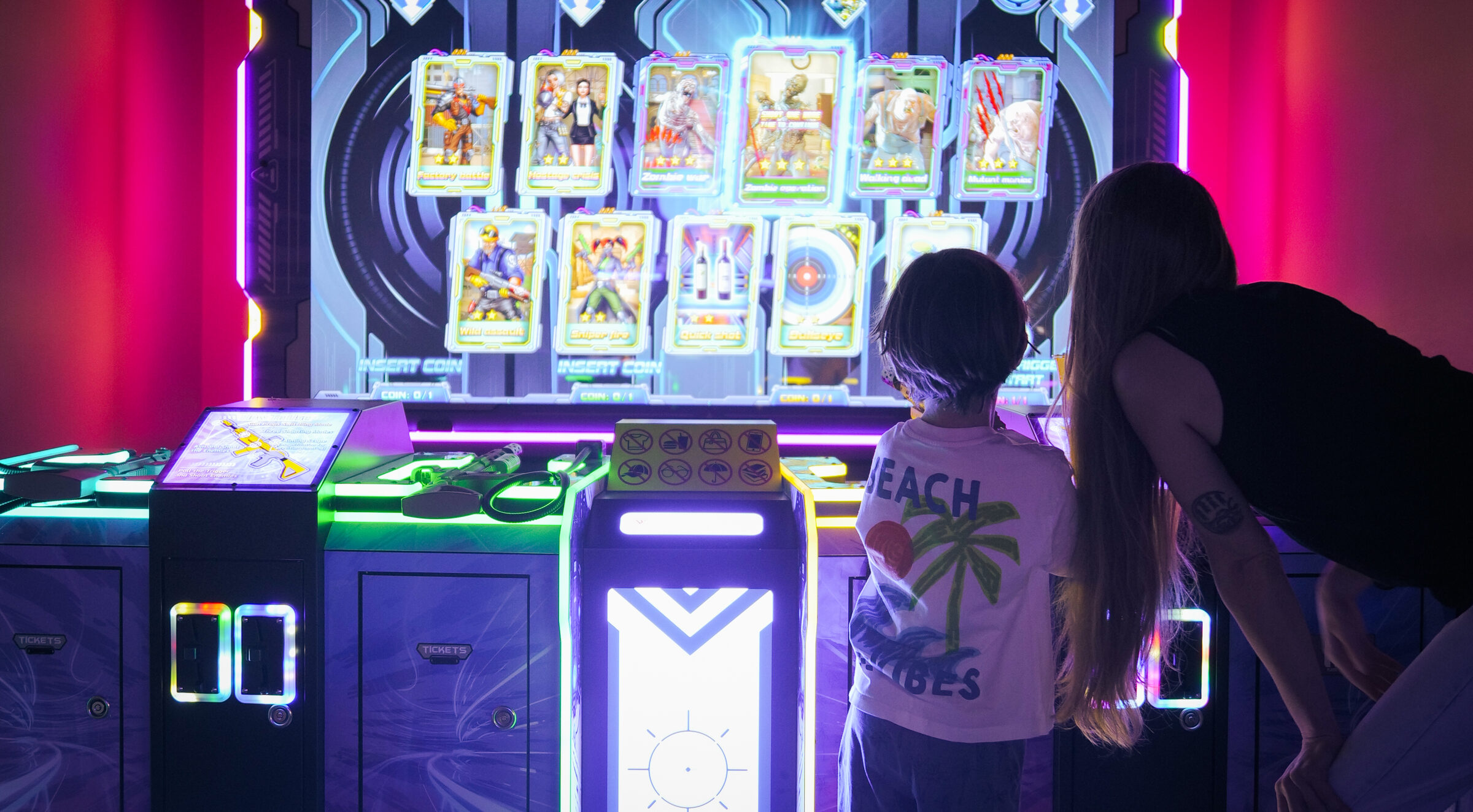 Children playing arcade machines at Yo Coast in Polzeath